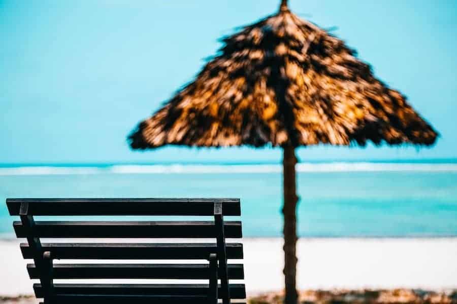 Beach lounge chair and umbrella on beach in Bali | Bali Beach Club