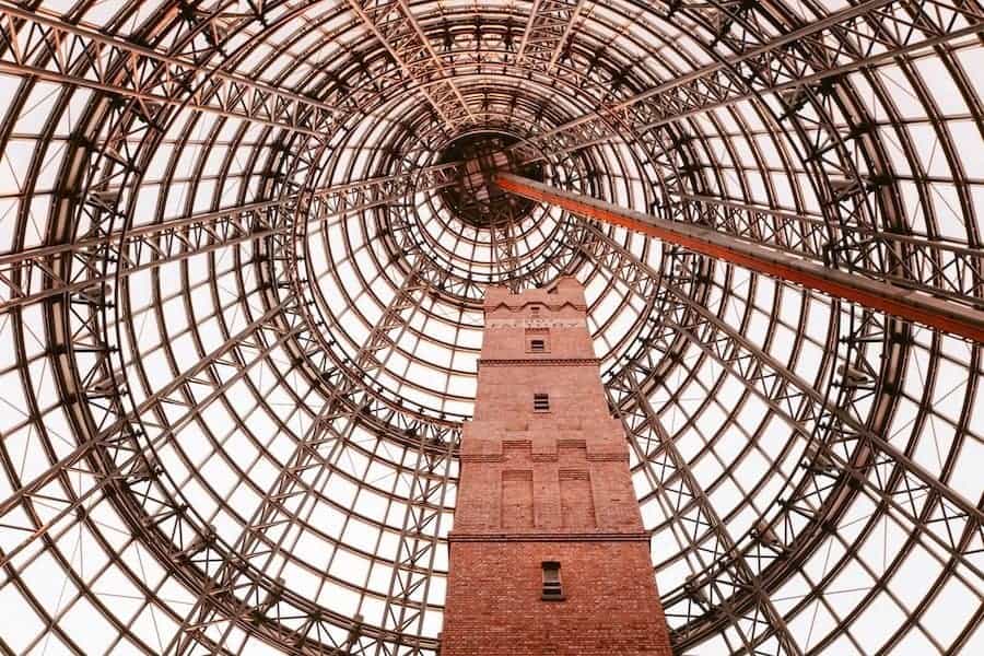 Melbourne Central shopping centre. An old red brick building house inside a glass and steel dome structure.