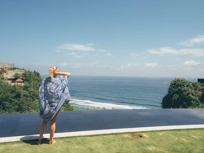 Girl wearing a Camilla beach cover-up overlooking the clifftops at The Ungasan resort in Bali