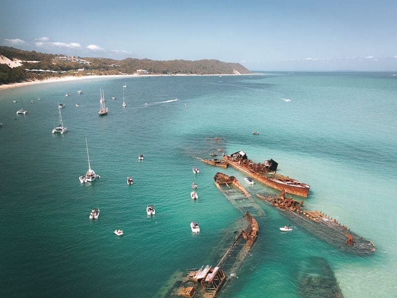 Tangalooma Wrecks on Moreton Island are a spectacular formation of shipwrecks located just off the coast of Brisbane, Queensland Australia. It’s possible to go camping on the beaches, see dolphins and whales or visit on a day trip #MoretonIsland #Australia #Queensland #DayTrip #thingstodo #Tangalooma