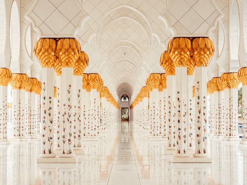 White marble hallways of the Sheikh Zayed Grand Mosque with gold leaf trim
