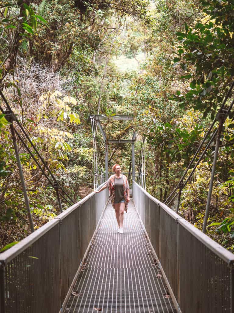 Girl walking along a suspension bridge at Mossman Gorge in the Daintree Rainforest